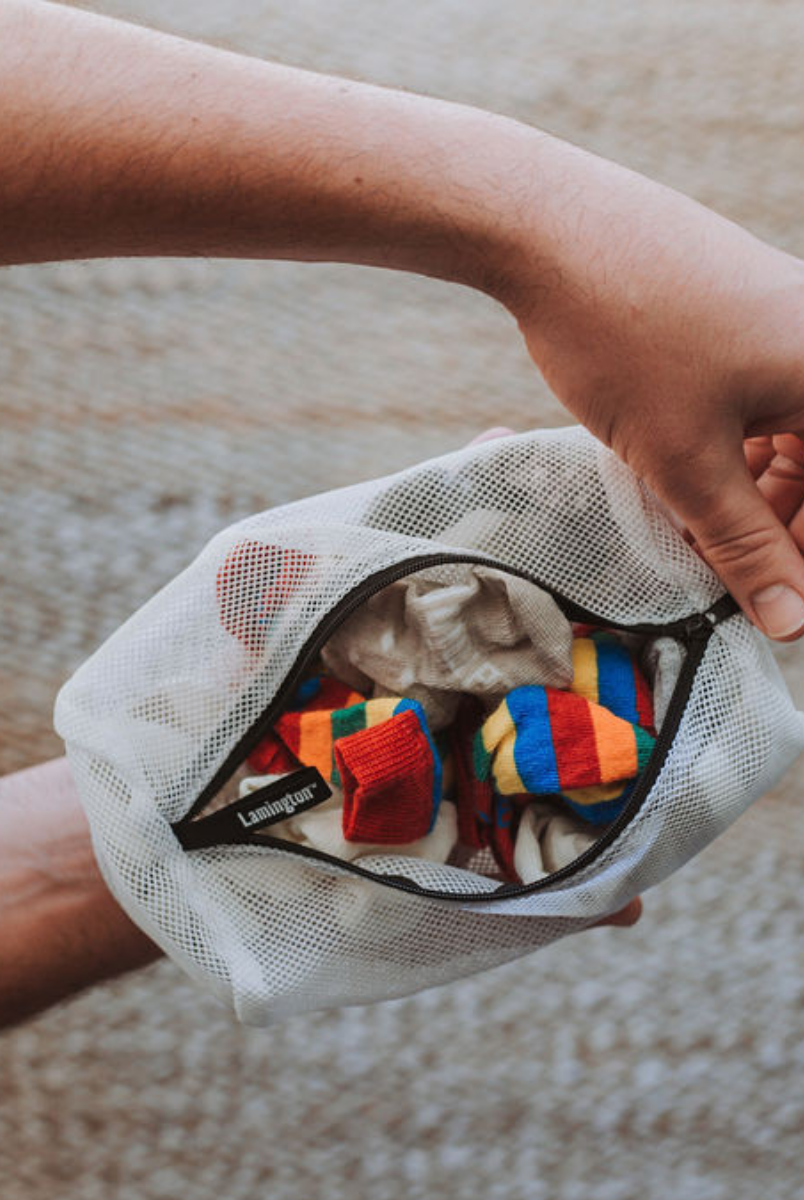 Sock-sized laundry bag with socks inside. Open zip