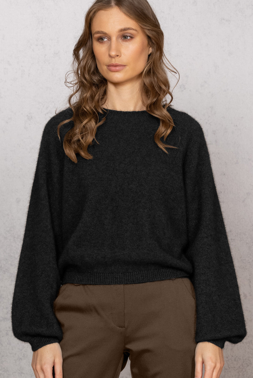 Woman wearing Noble Wilde - Merino & Possum Bellow Sleeve Top in the colour Black.