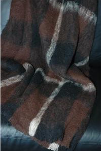 Draped Alpaca fleece throw in Buffalo colour on couch.
