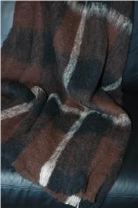 Draped Alpaca fleece throw in Buffalo colour on couch.