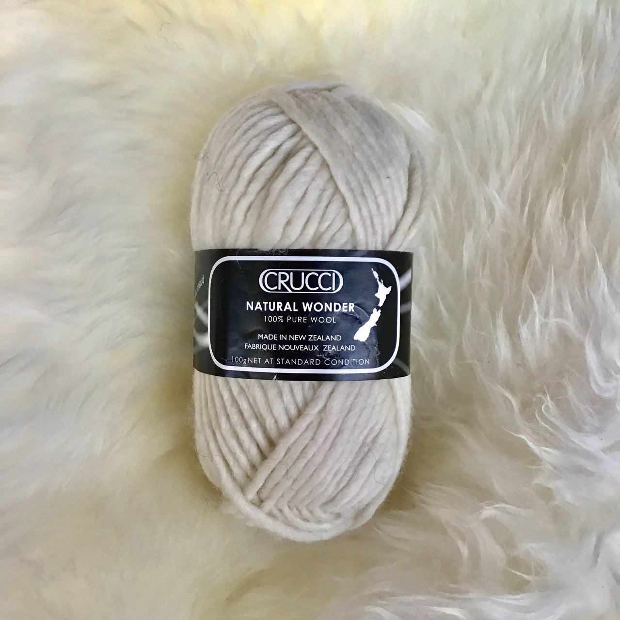 Ball of yarn in colour cream.