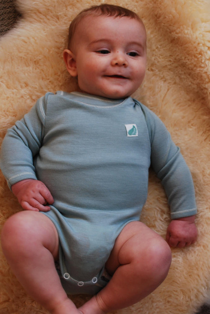 Merino wool long sleeved babies’ bodysuit in blue.