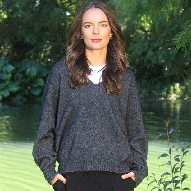 Woman wearing the Lothlorian - Merino & Possum Cavern V Neck Jumper (9789) in the colour Charcoal.