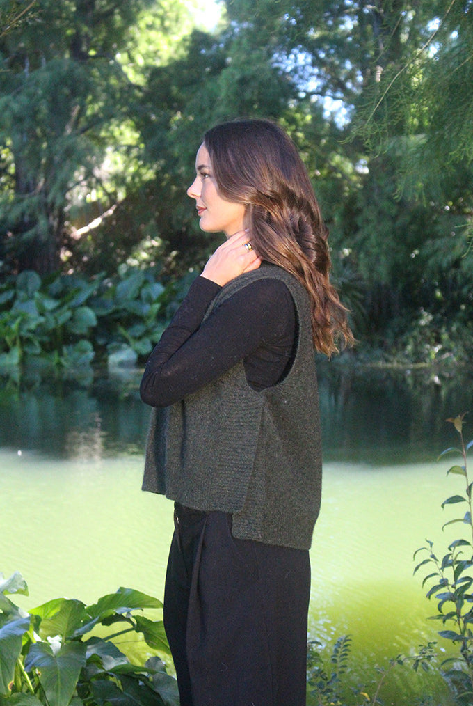 Woman wearing the Lothlorian - Merino & Possum Ride Vest (9650) in the colour Moss.