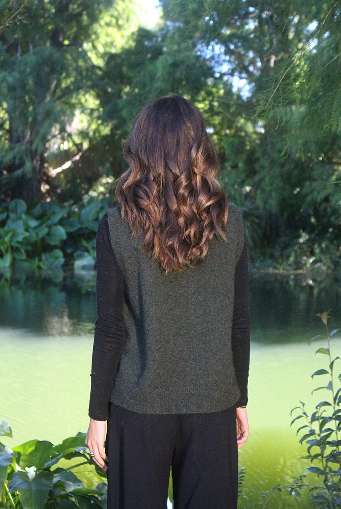 Woman wearing the Lothlorian - Merino & Possum Ride Vest (9650) in the colour Moss.