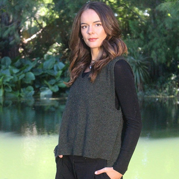 Woman wearing the Lothlorian - Merino & Possum Ride Vest (9650) in the colour Moss.