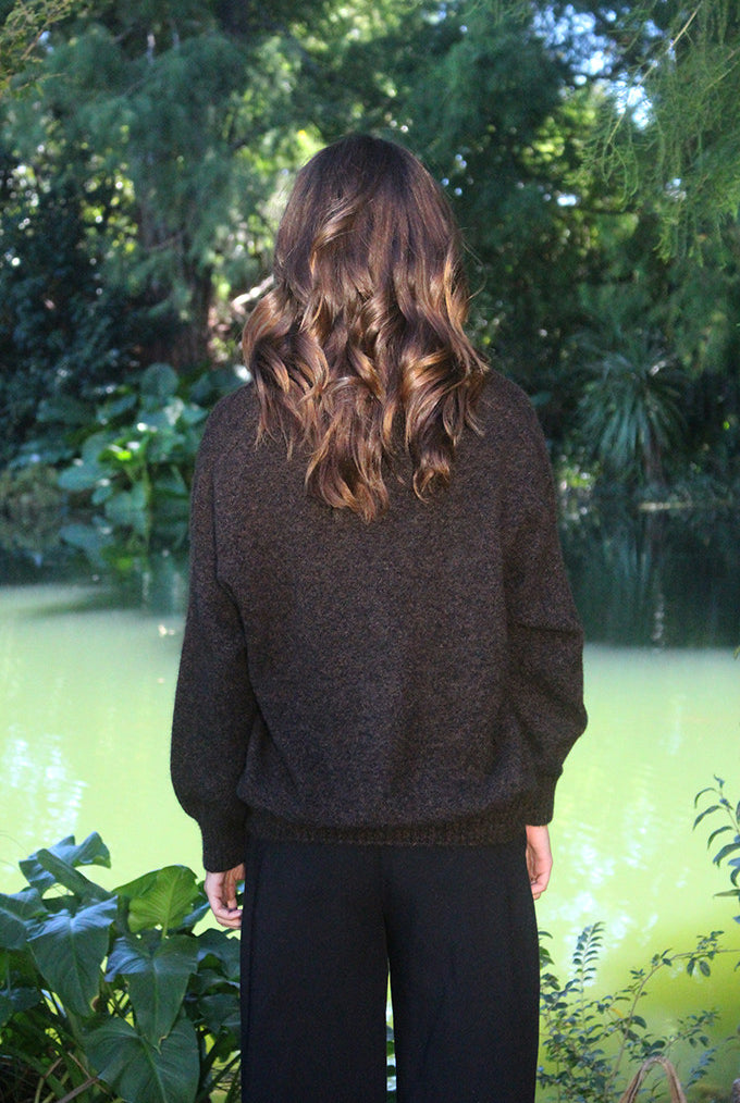 Woman wearing the Lothlorian - Merino & Possum Cavern V Neck Jumper (9789) in the colour Brown Marl.