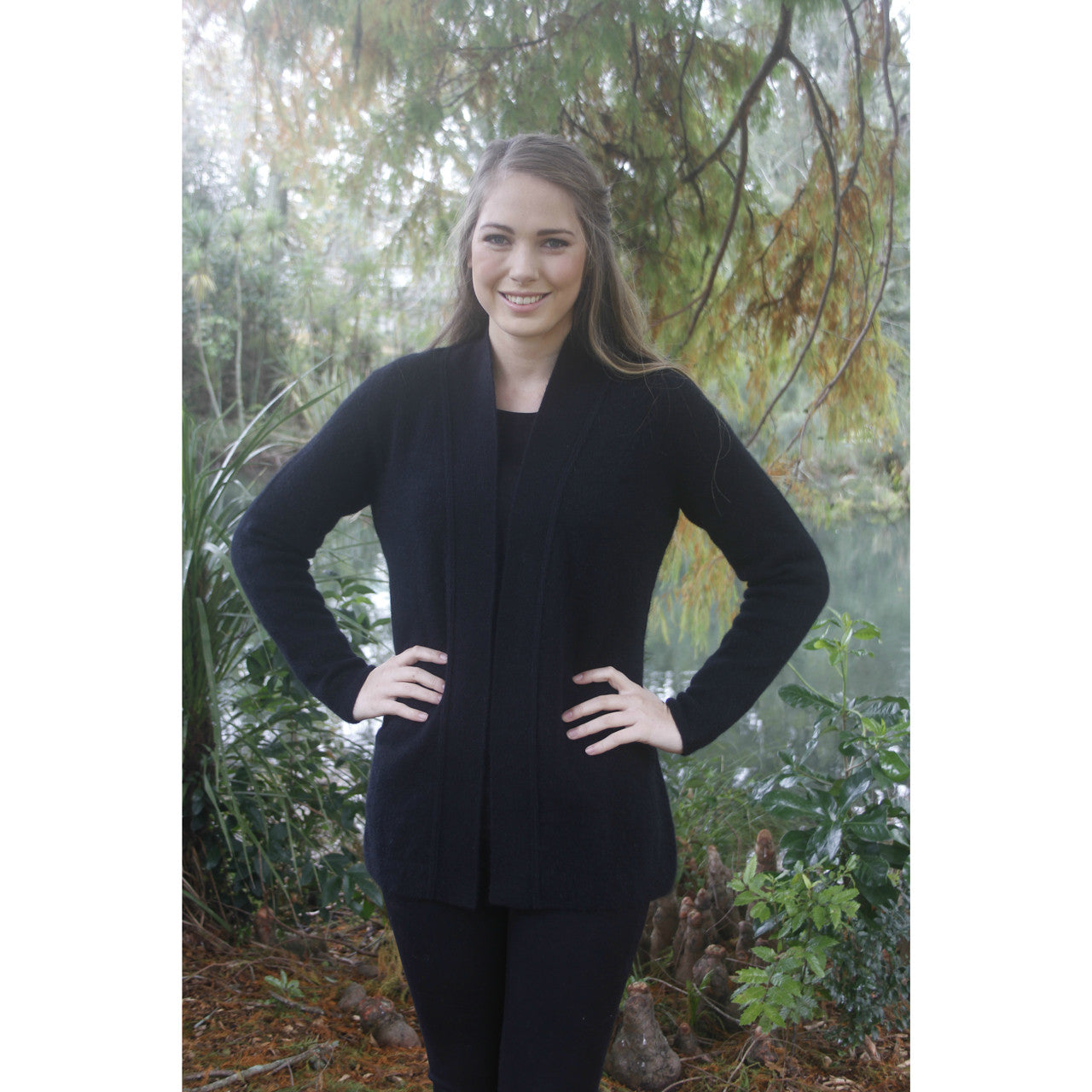 Woman with hands on hips wearing Black relaxed jacket