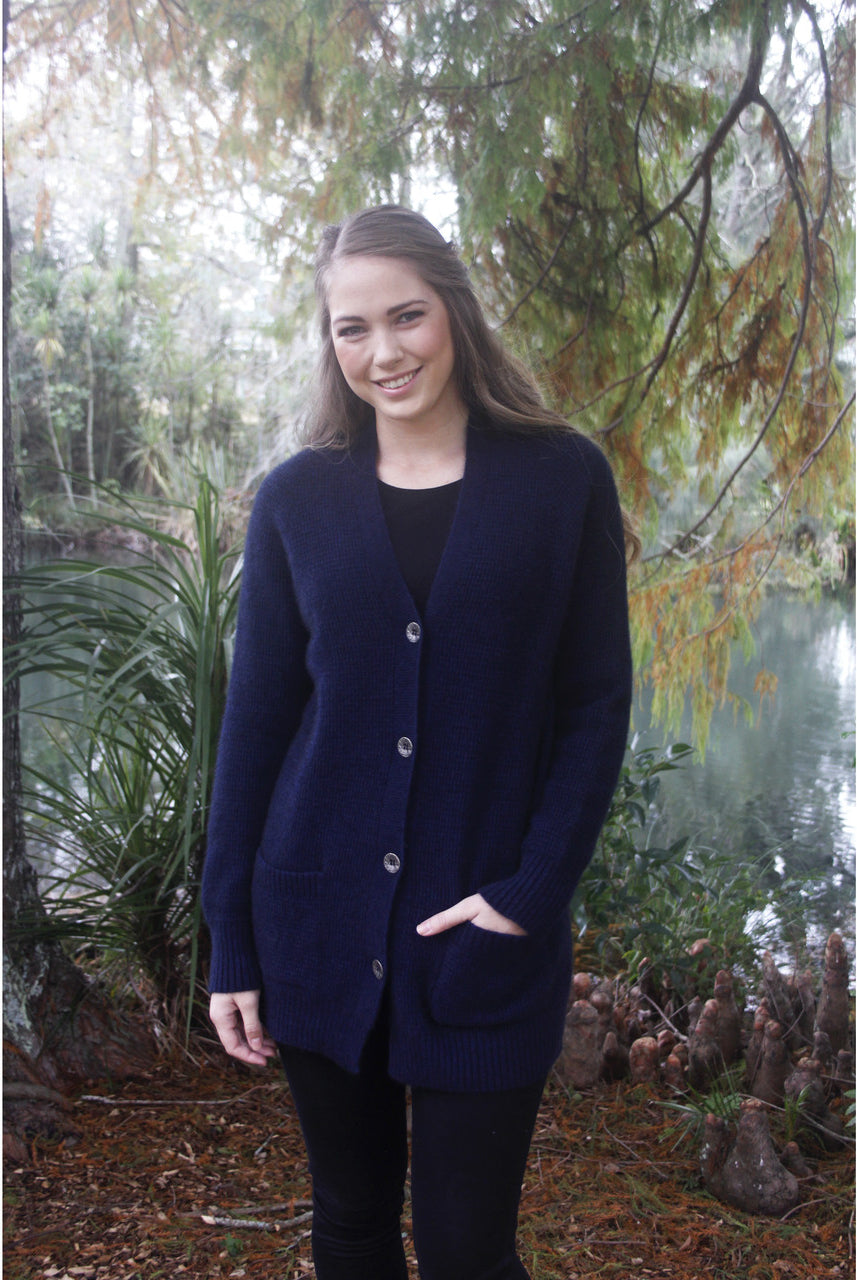Woman standing. Wearing boyfriend cardigan in Midnight colour