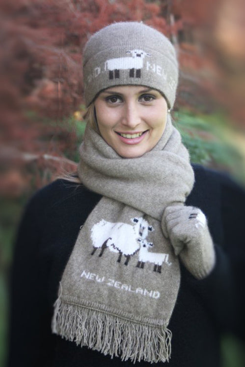 Woman wearing beanie and scarf with sheep picture