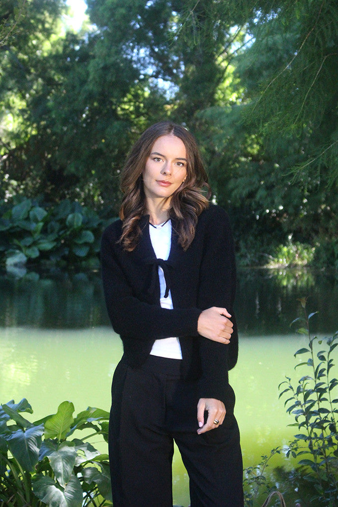 Woman wearing the Lothlorian - Merino & Possum Fuse Tie Jacket (9972) in the colour Black.