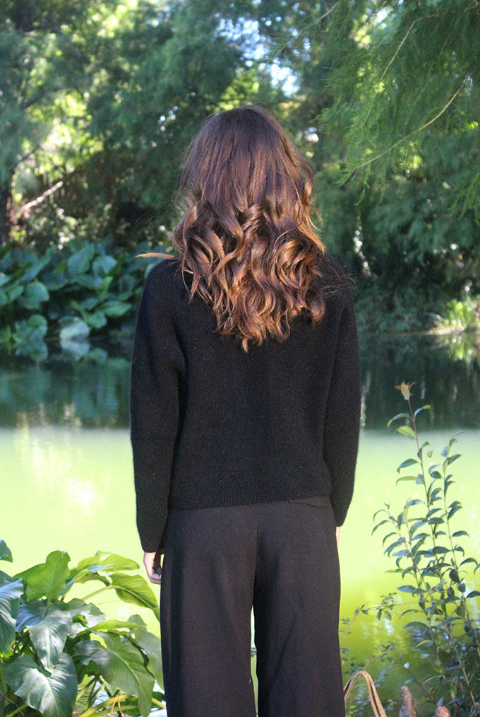 Woman wearing the Lothlorian - Merino & Possum Fuse Tie Jacket (9972) in the colour Black.