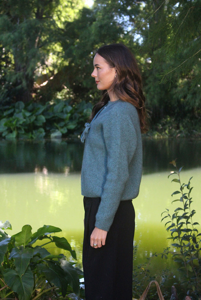 Woman wearing the Lothlorian - Merino & Possum Fuse Tie Jacket (9972) in the colour Sage.