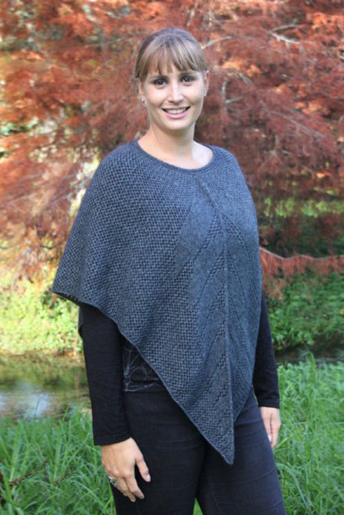 Blonde woman wearing poncho. Colour Charcoal