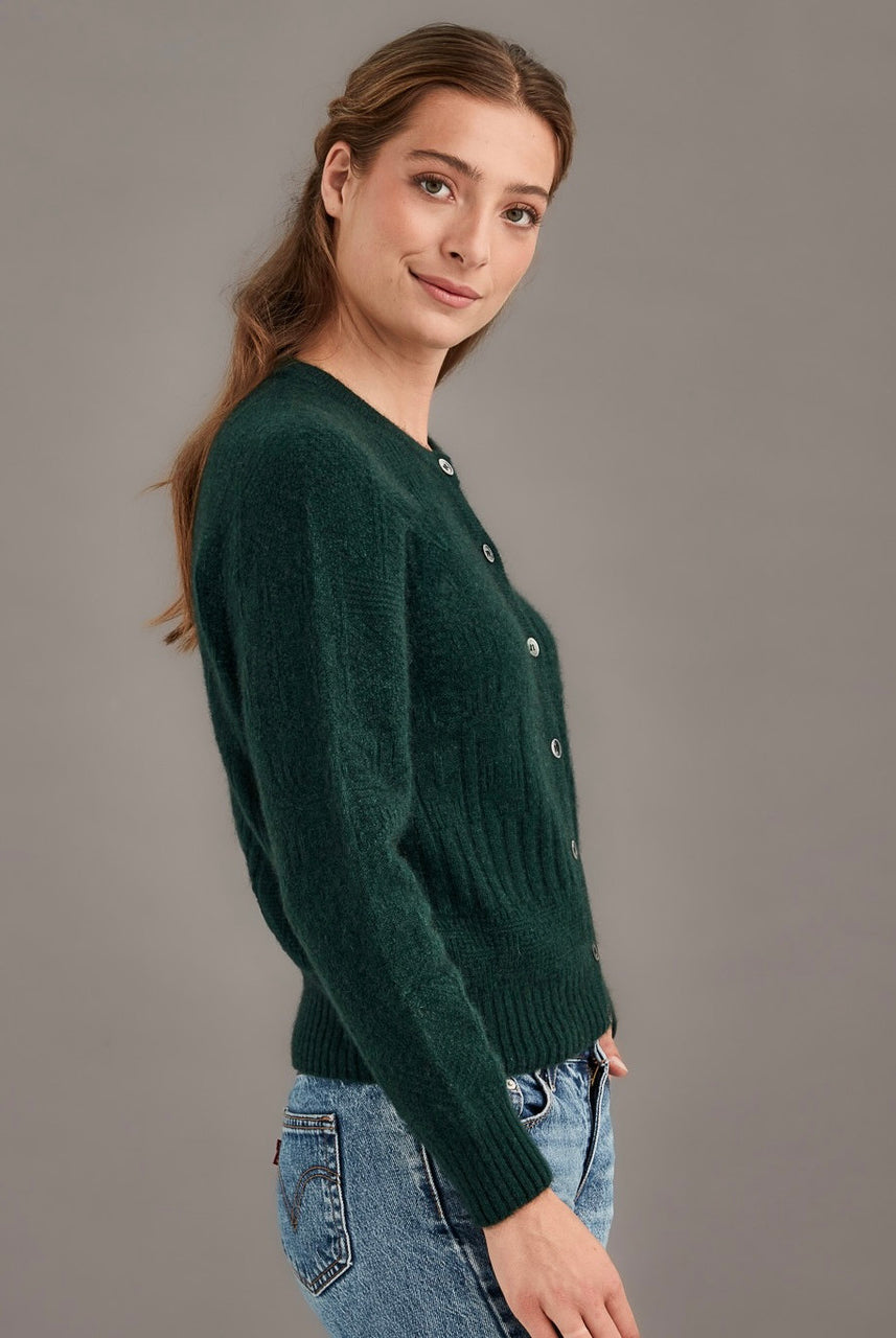 Woman wearing McDonald - Merino & Possum Patchwork Cardigan (5062) in the colour Forest.