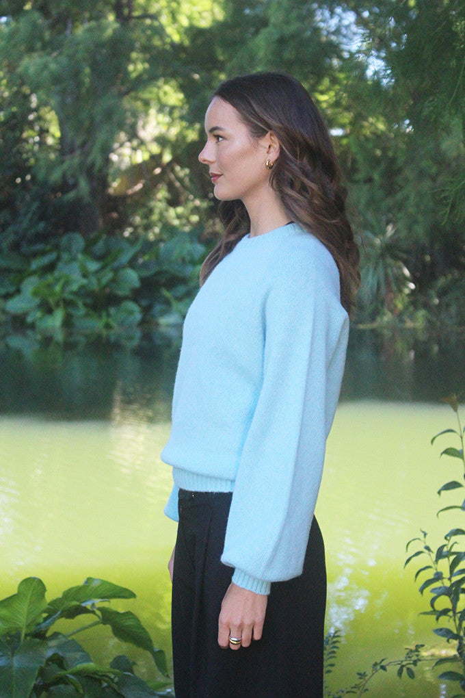 Woman wearing the Lothlorian - Alpaca Chime Jumper (ALP079) in the colour Aqua.