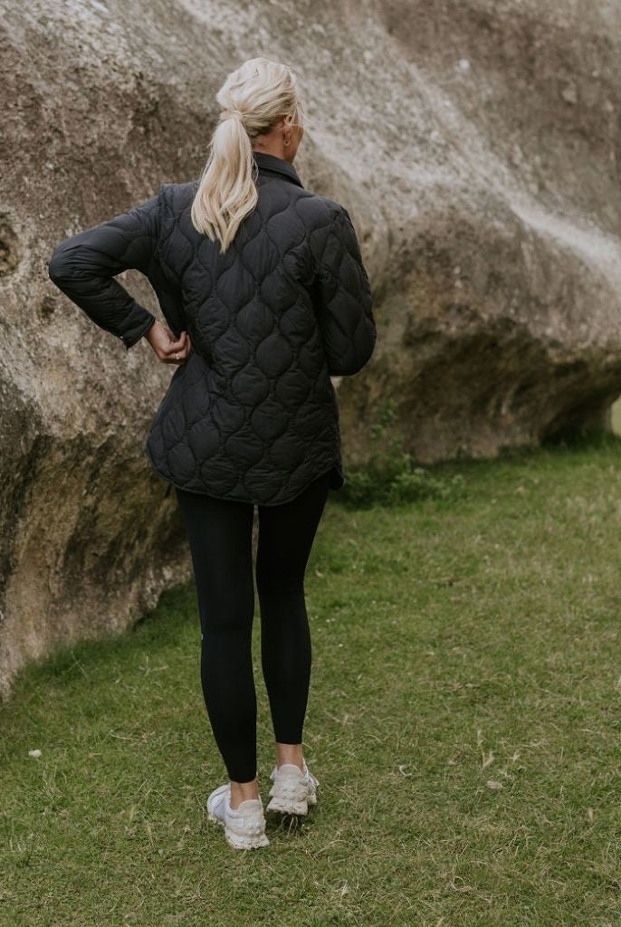 Woman wearing Moke - Ash Down Overshirt in the colour Black.