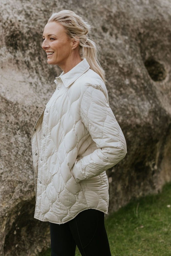 Woman wearing Moke - Ash Down Overshirt in the colour Cream.