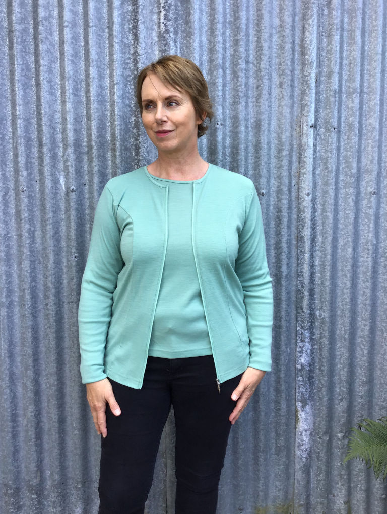 Woman wearing zipped Catherine Cardigan in Atoll