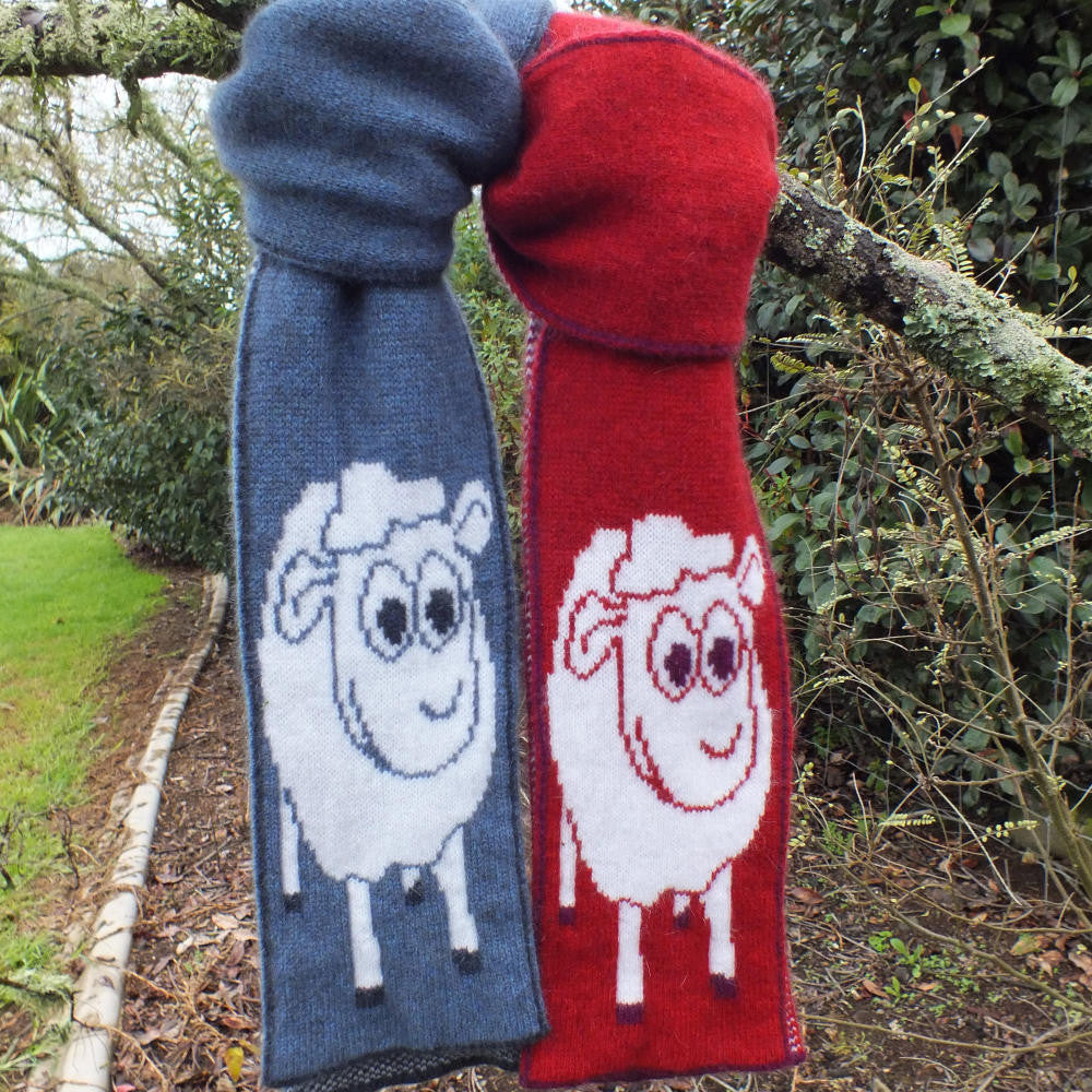 Two scarves hanging in colours blue & red.
