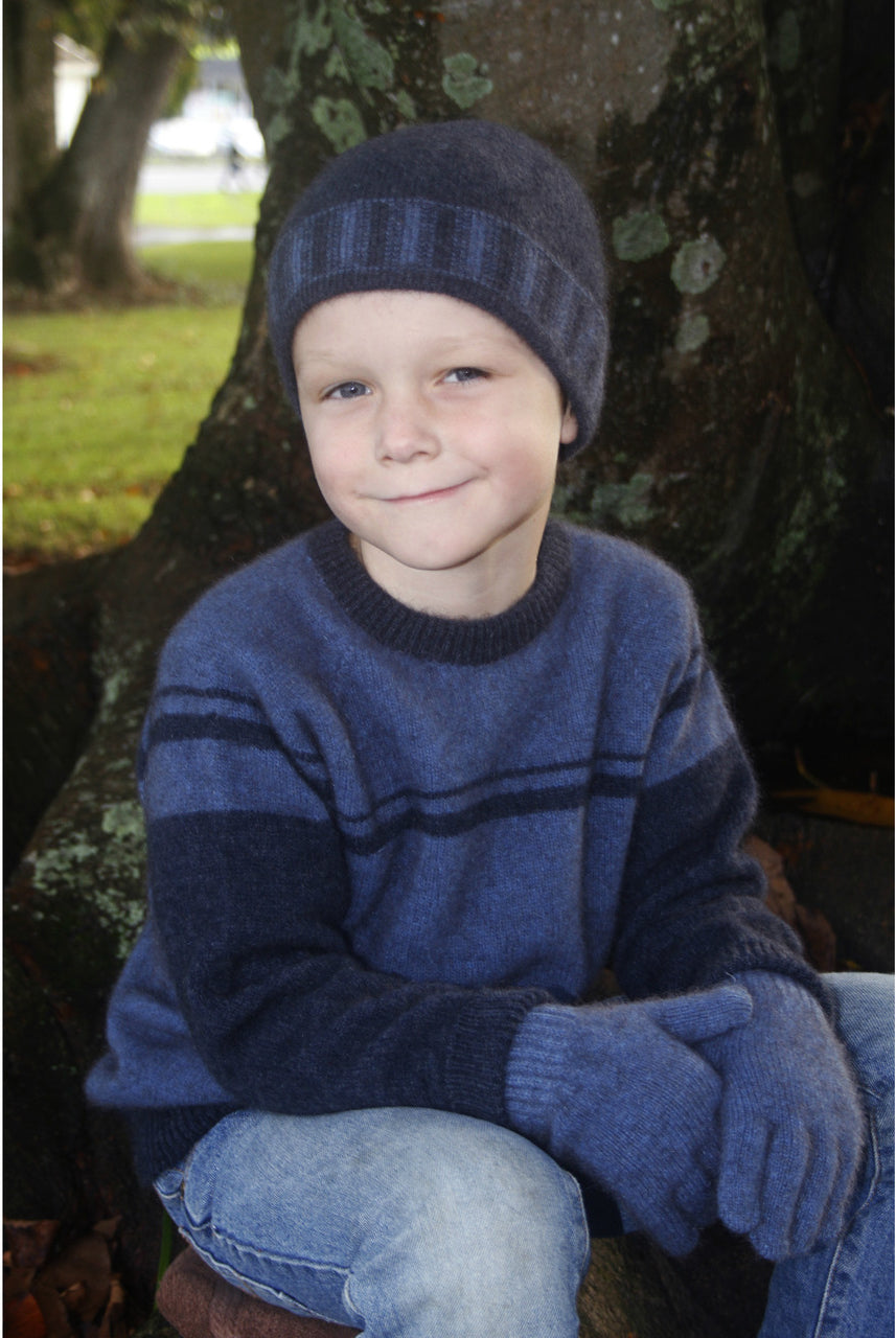 Boy sitting wearing Denim colour jumper.