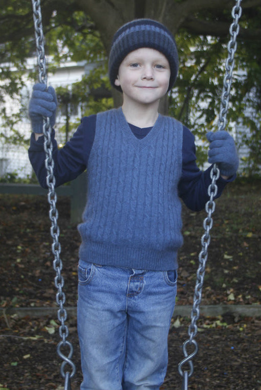 Boy holding swing wearing light blue colour vest.