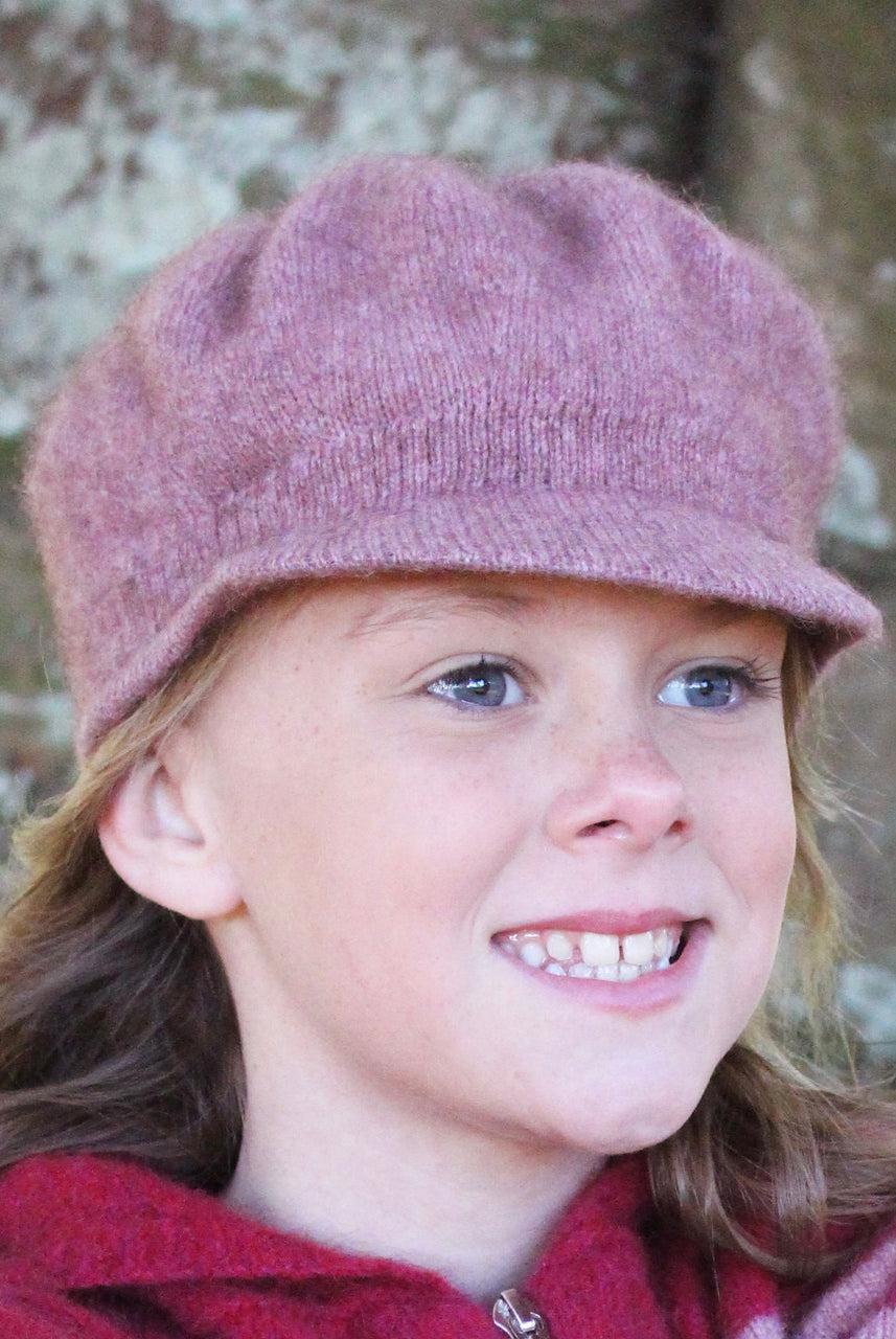 Girl smiling wearing pink Gatsby hat.
