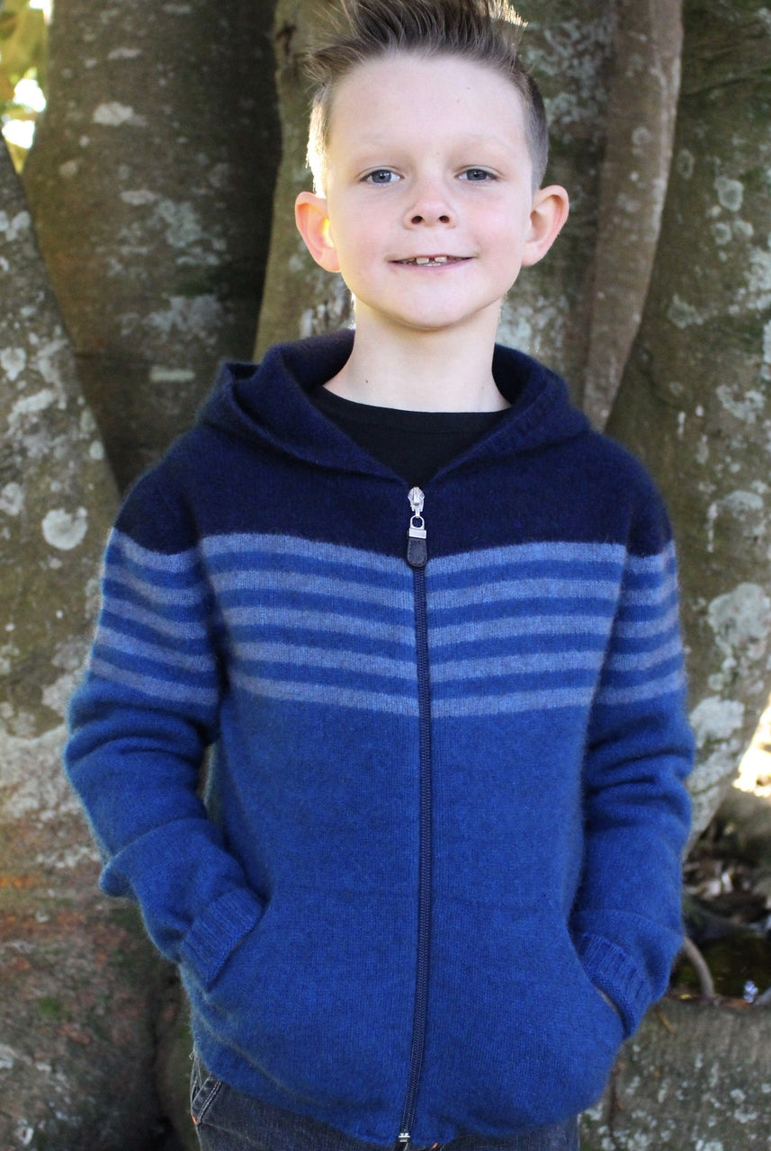 Boy standing wearing lagoon colour striped hoodie.