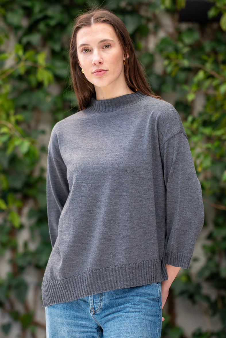 Woman wearing Country Laine - Slant Jumper (CL0115-IND2026) in the colour Dark Grey.