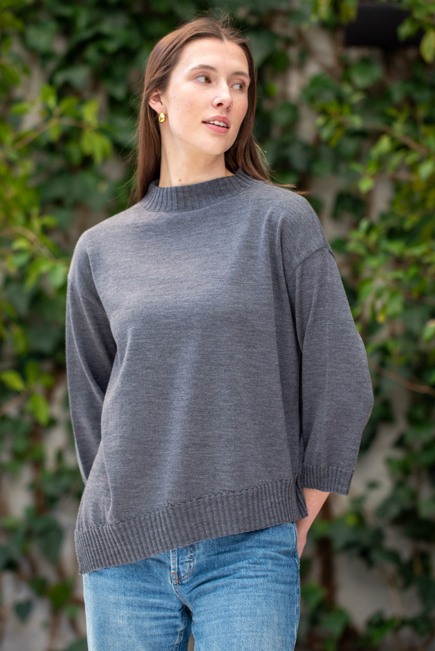 Woman wearing Country Laine - Slant Jumper (CL0115-IND2026) in the colour Dark Grey.