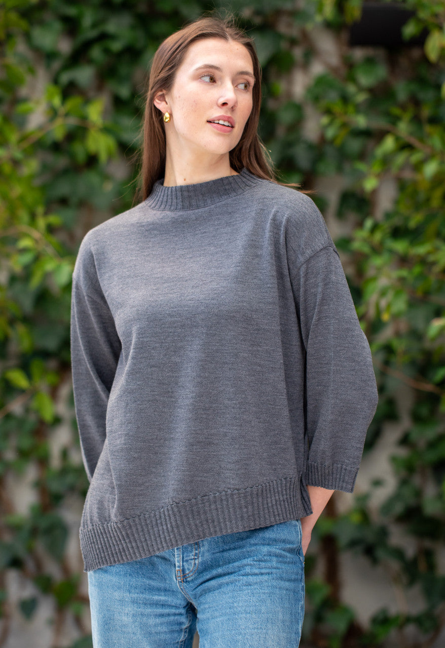 Woman wearing Country Laine - Slant Jumper (CL0115-IND2026) in the colour Dark Grey.