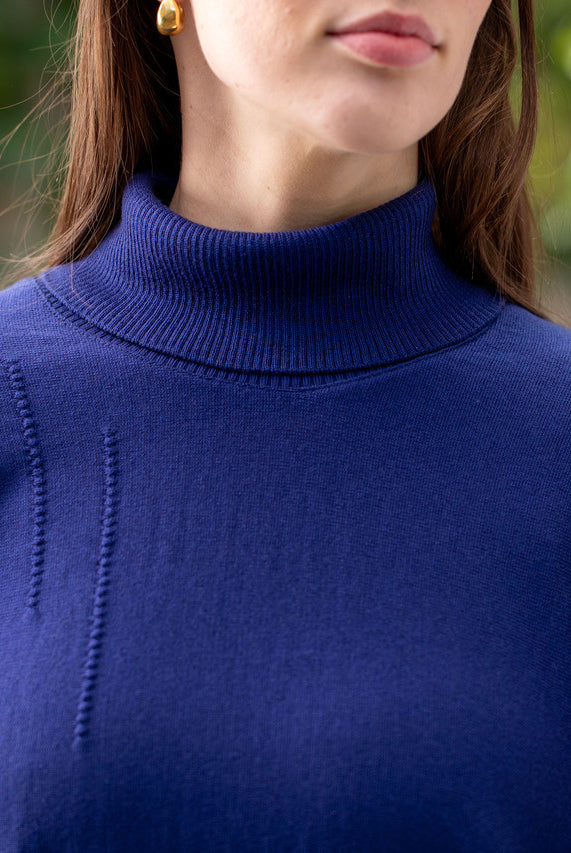 Woman wearing Country Laine - High Neck Sway Jumper (CL0122-IND2026) in the colour Atlantic.