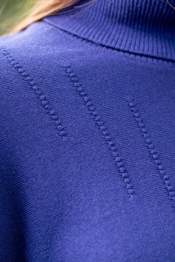 Woman wearing Country Laine - High Neck Sway Jumper (CL0122-IND2026) in the colour Atlantic.