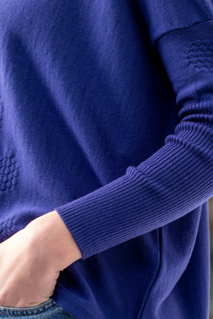 Woman wearing Country Laine - High Neck Sway Jumper (CL0122-IND2026) in the colour Atlantic.