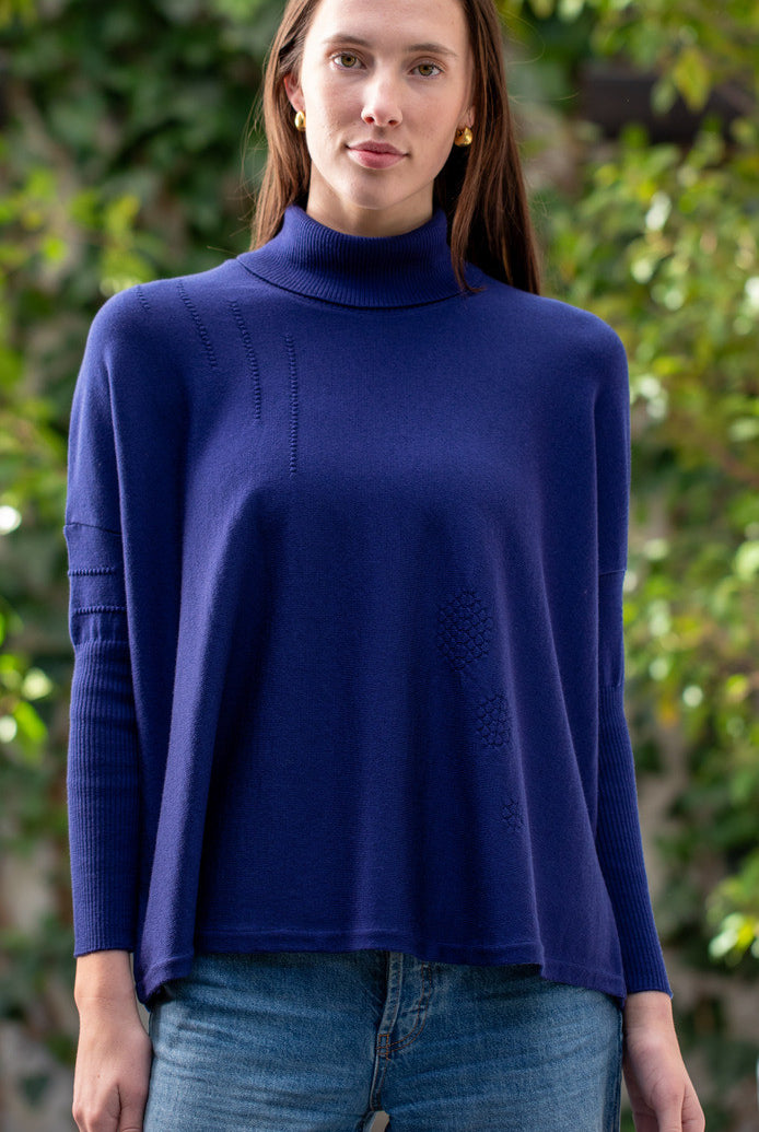 Woman wearing Country Laine - High Neck Sway Jumper (CL0122-IND2026) in the colour Atlantic.