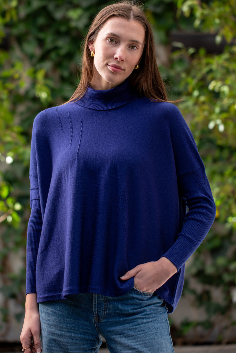 Woman wearing Country Laine - High Neck Sway Jumper (CL0122-IND2026) in the colour Atlantic.