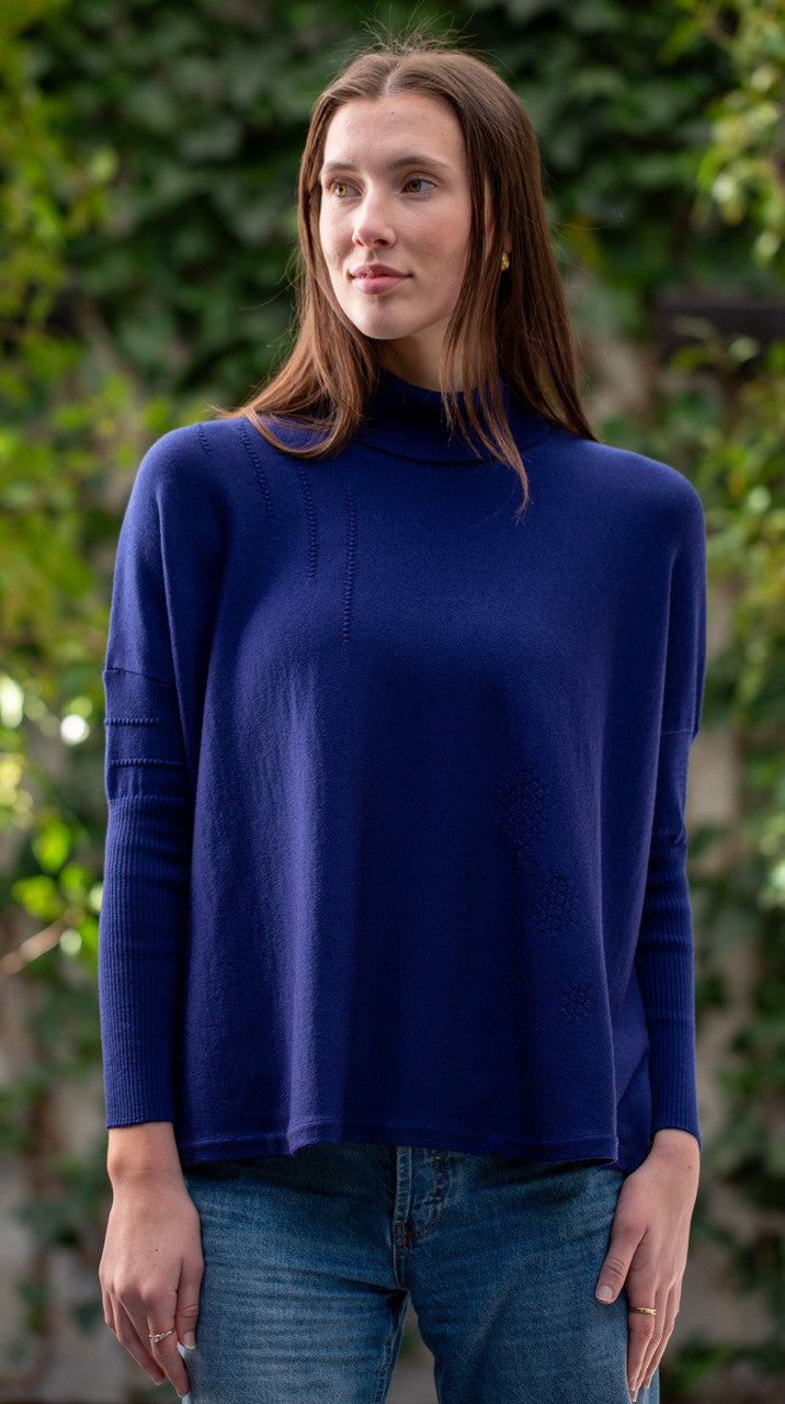 Woman wearing Country Laine - High Neck Sway Jumper (CL0122-IND2026) in the colour Atlantic.