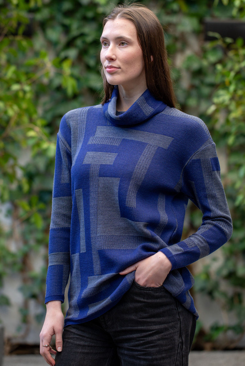 Woman wearing Country Laine - Cubist Jumper (CL0123L-IND2026) in the colour Atlantic/Dark Grey.