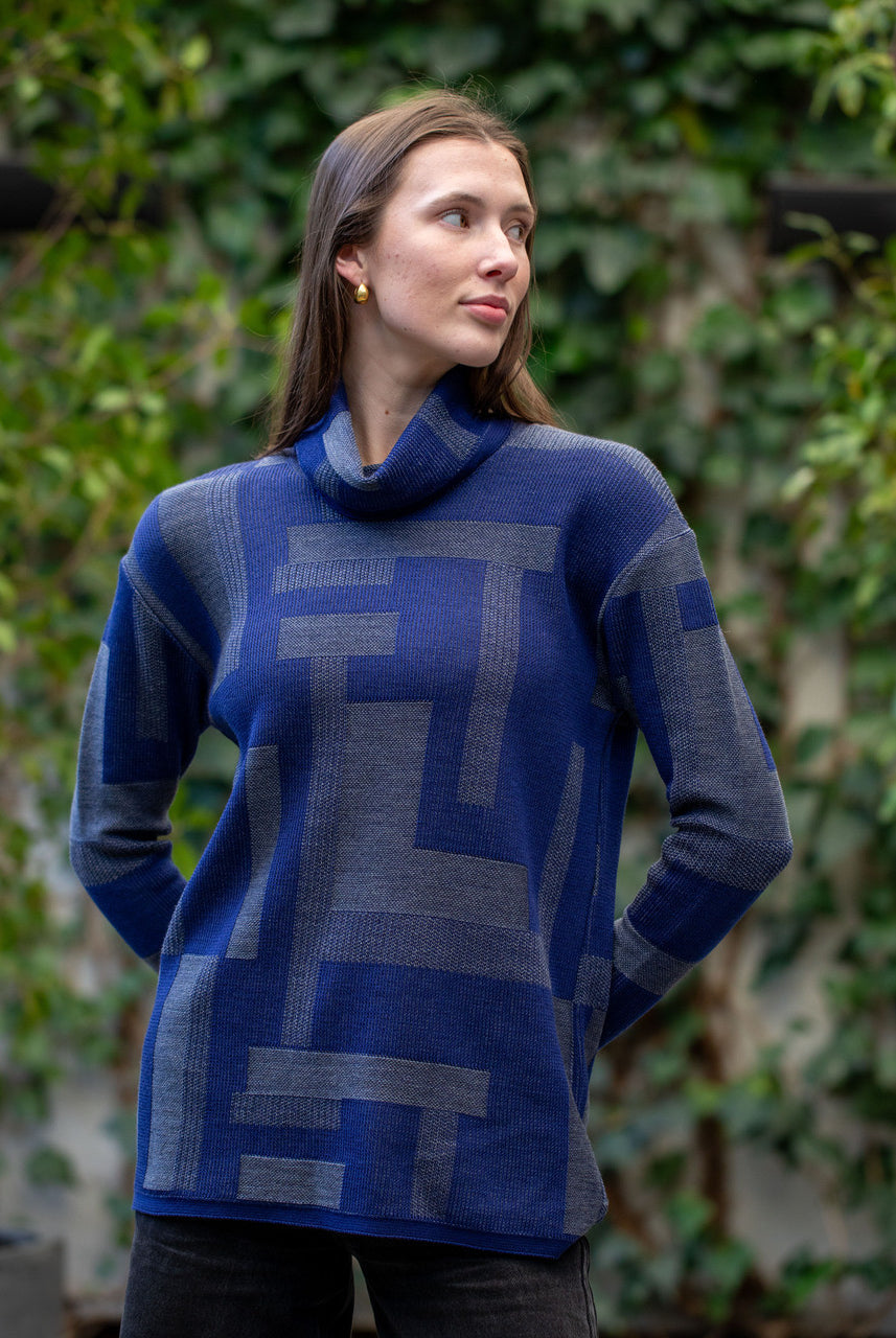 Woman wearing Country Laine - Cubist Jumper (CL0123L-IND2026) in the colour Atlantic/Dark Grey.