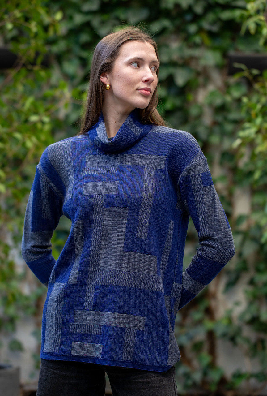 Woman wearing Country Laine - Cubist Jumper (CL0123L-IND2026) in the colour Atlantic/Dark Grey.