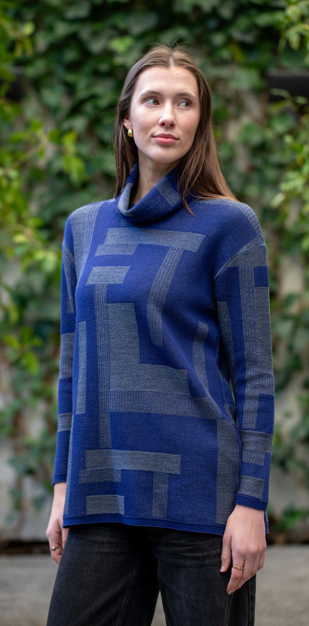 Woman wearing Country Laine - Cubist Jumper (CL0123L-IND2026) in the colour Atlantic/Dark Grey.