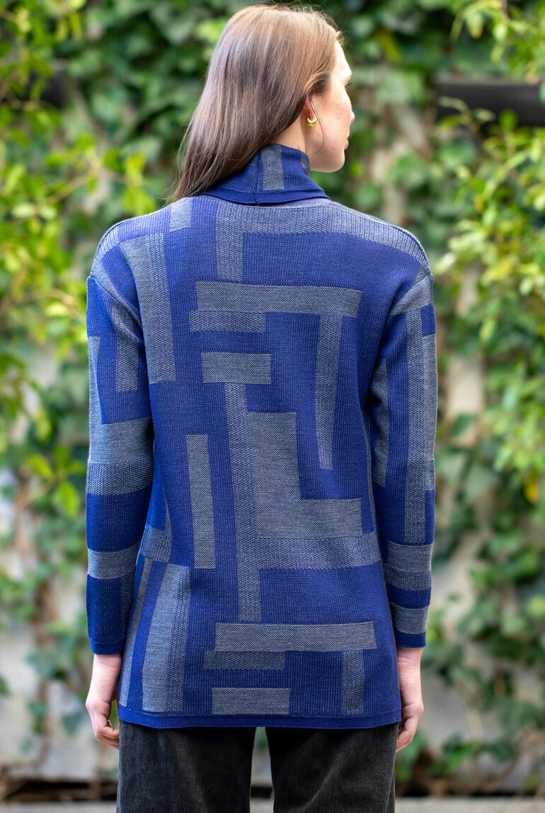 Woman wearing Country Laine - Cubist Jumper (CL0123L-IND2026) in the colour Atlantic/Dark Grey.