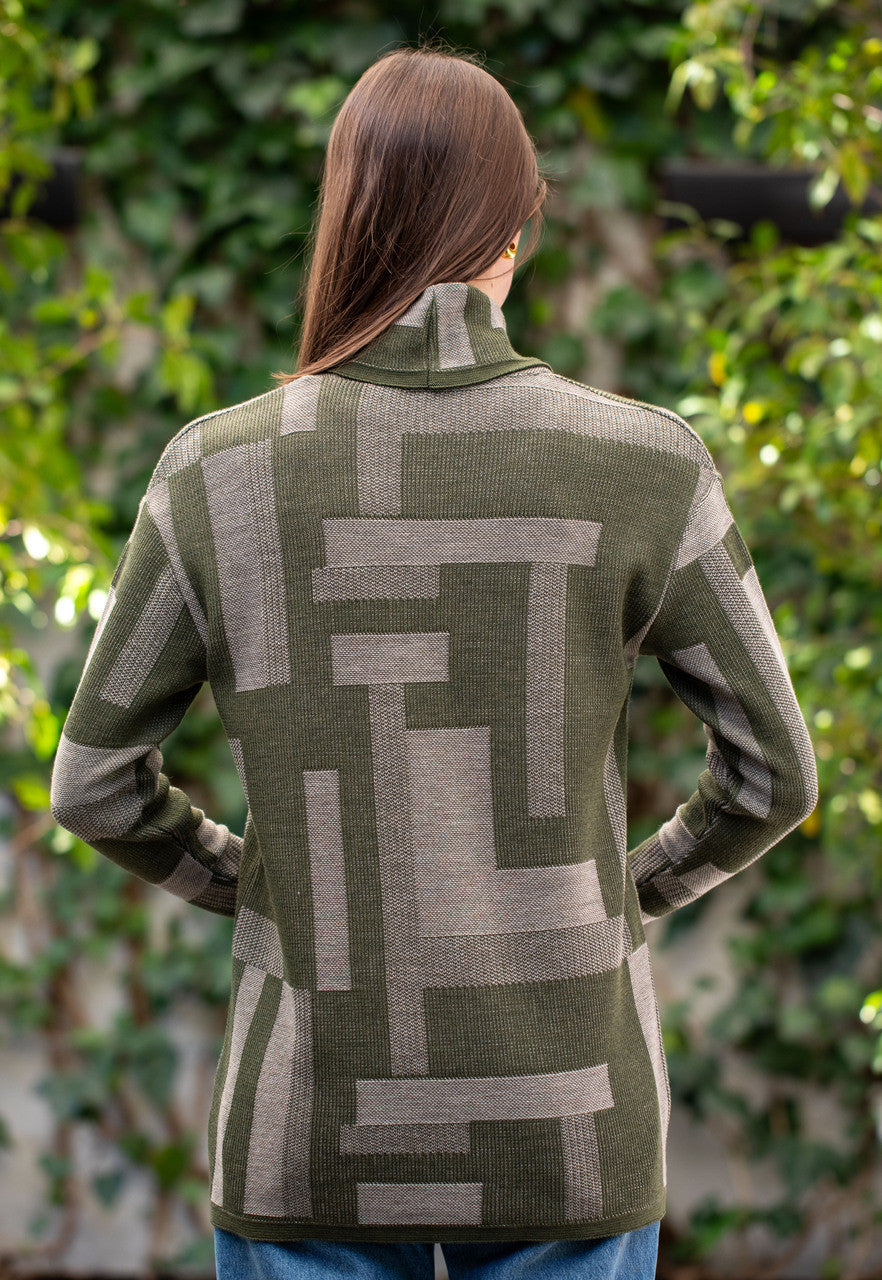 Woman wearing Country Laine - Cubist Jumper (CL0123L-IND2026) in the colour Olive/Chateau.