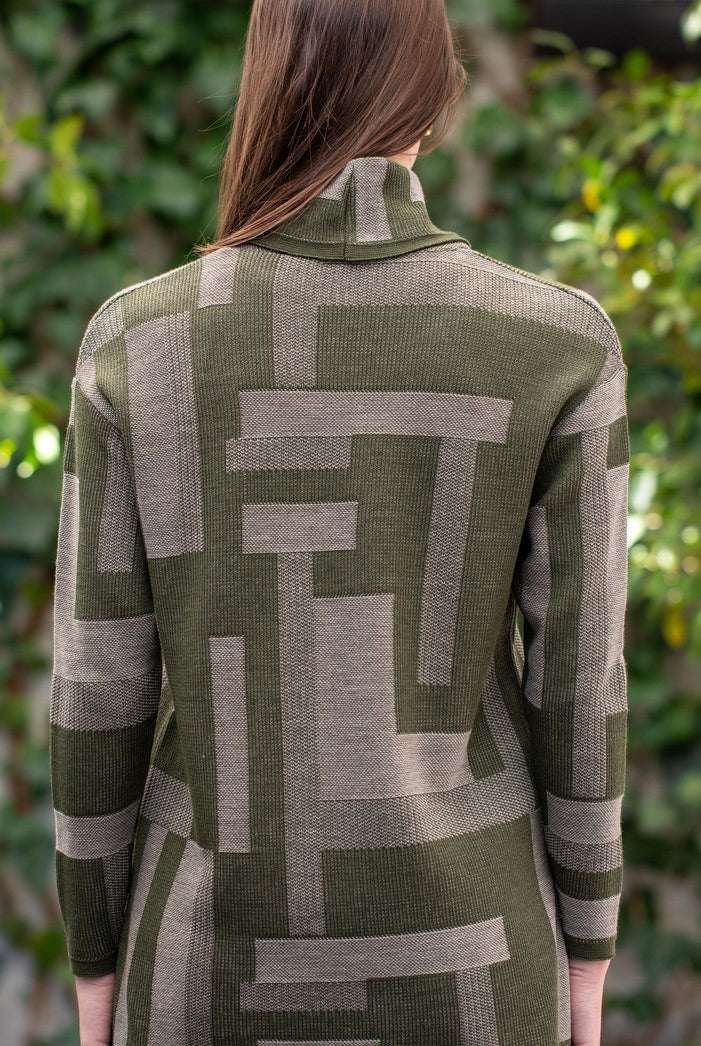 Woman wearing Country Laine - Cubist Jumper (CL0123L-IND2026) in the colour Olive/Chateau.