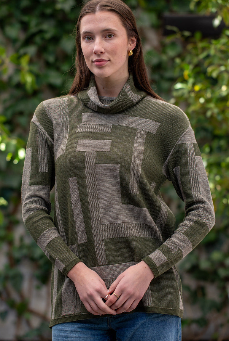 Woman wearing Country Laine - Cubist Jumper (CL0123L-IND2026) in the colour Olive/Chateau.