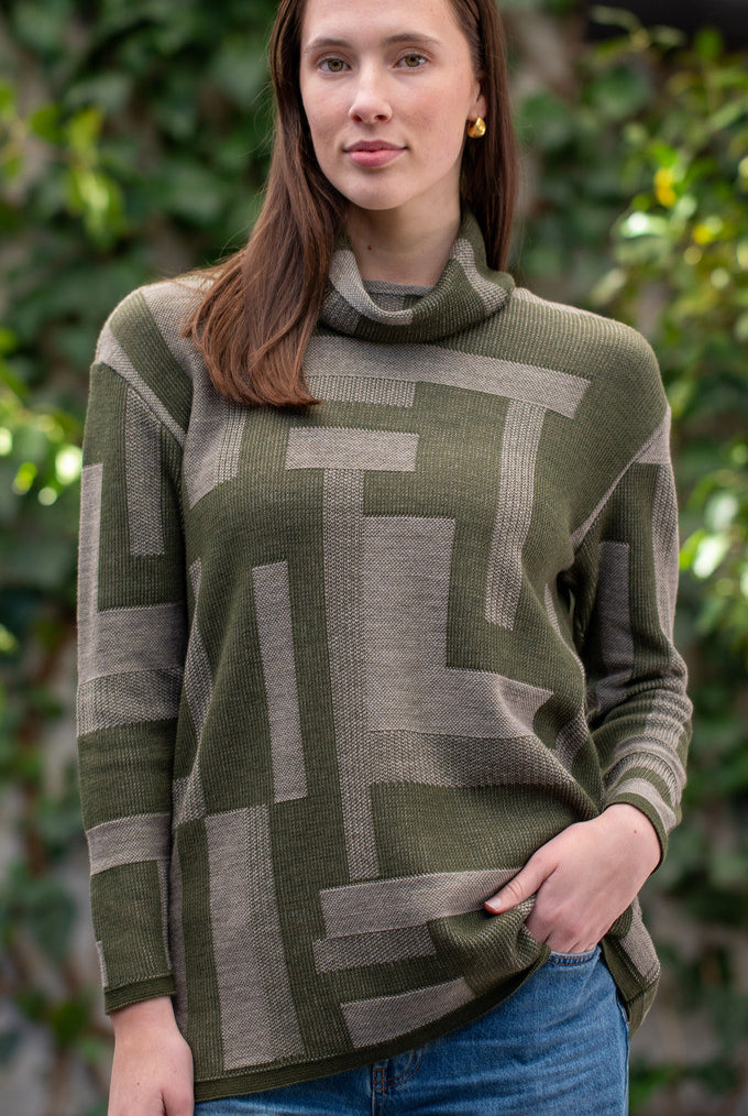 Woman wearing Country Laine - Cubist Jumper (CL0123L-IND2026) in the colour Olive/Chateau.