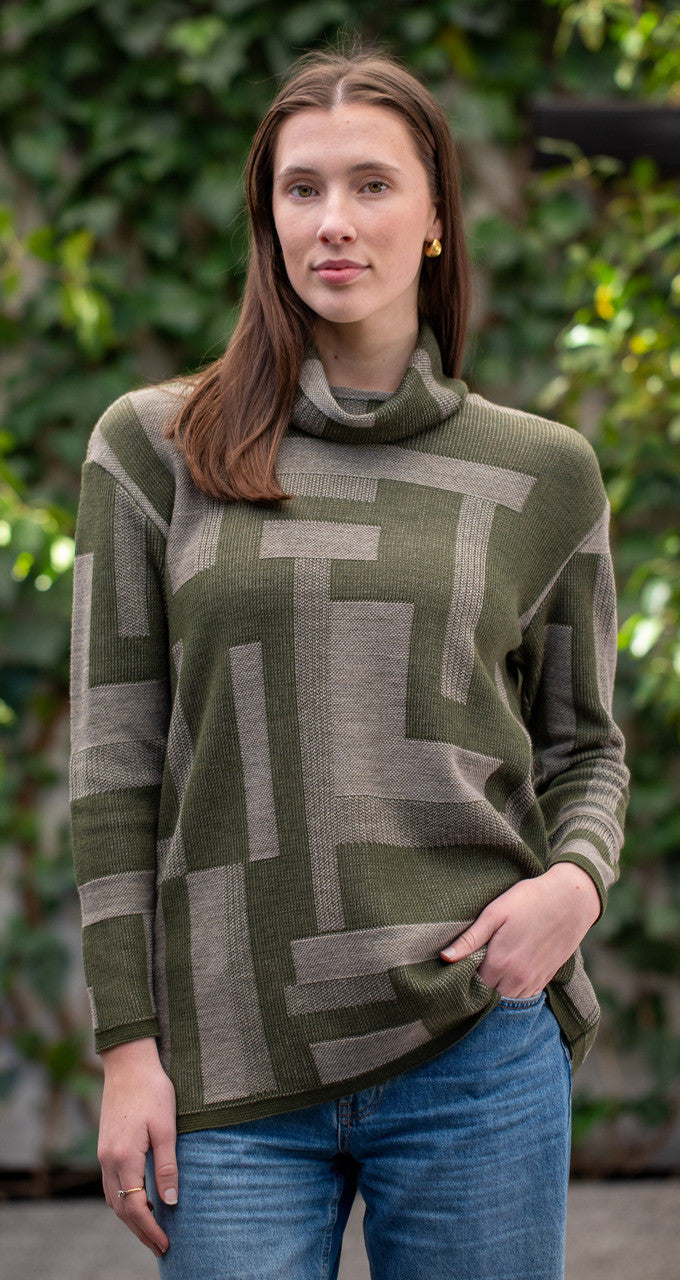 Woman wearing Country Laine - Cubist Jumper (CL0123L-IND2026) in the colour Olive/Chateau.