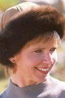 Woman wearing a Tan coloured Four Peaks Classic Panelled Lambskin & Possum Fur Hat.