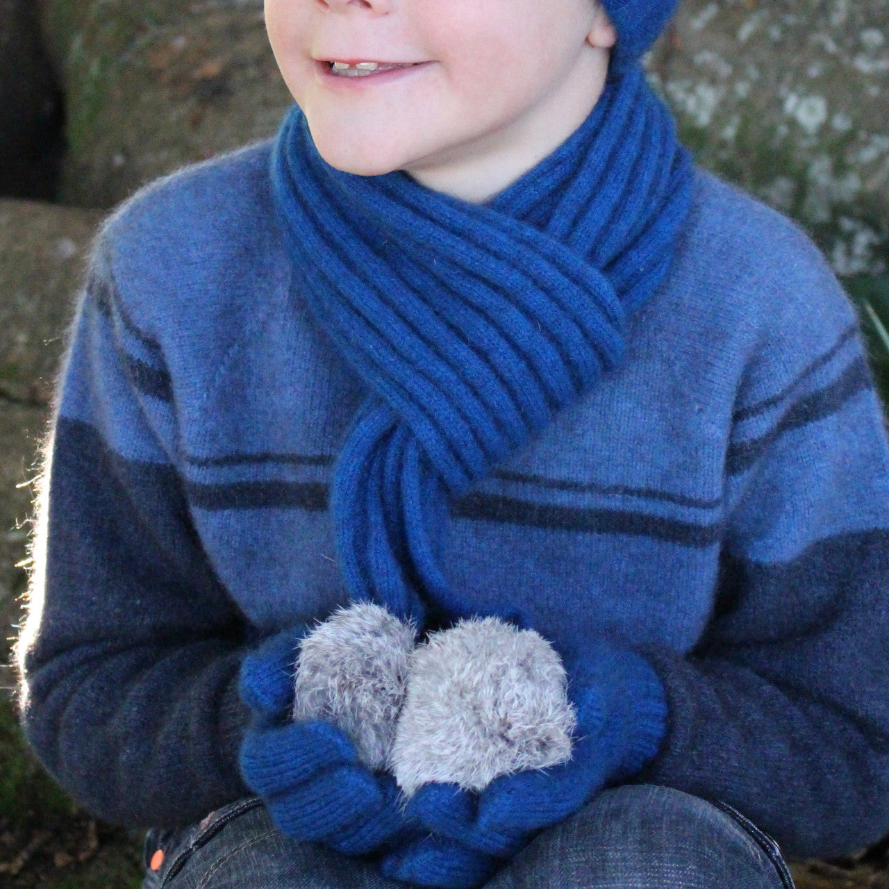Boy wearing lagoon colour scarf.