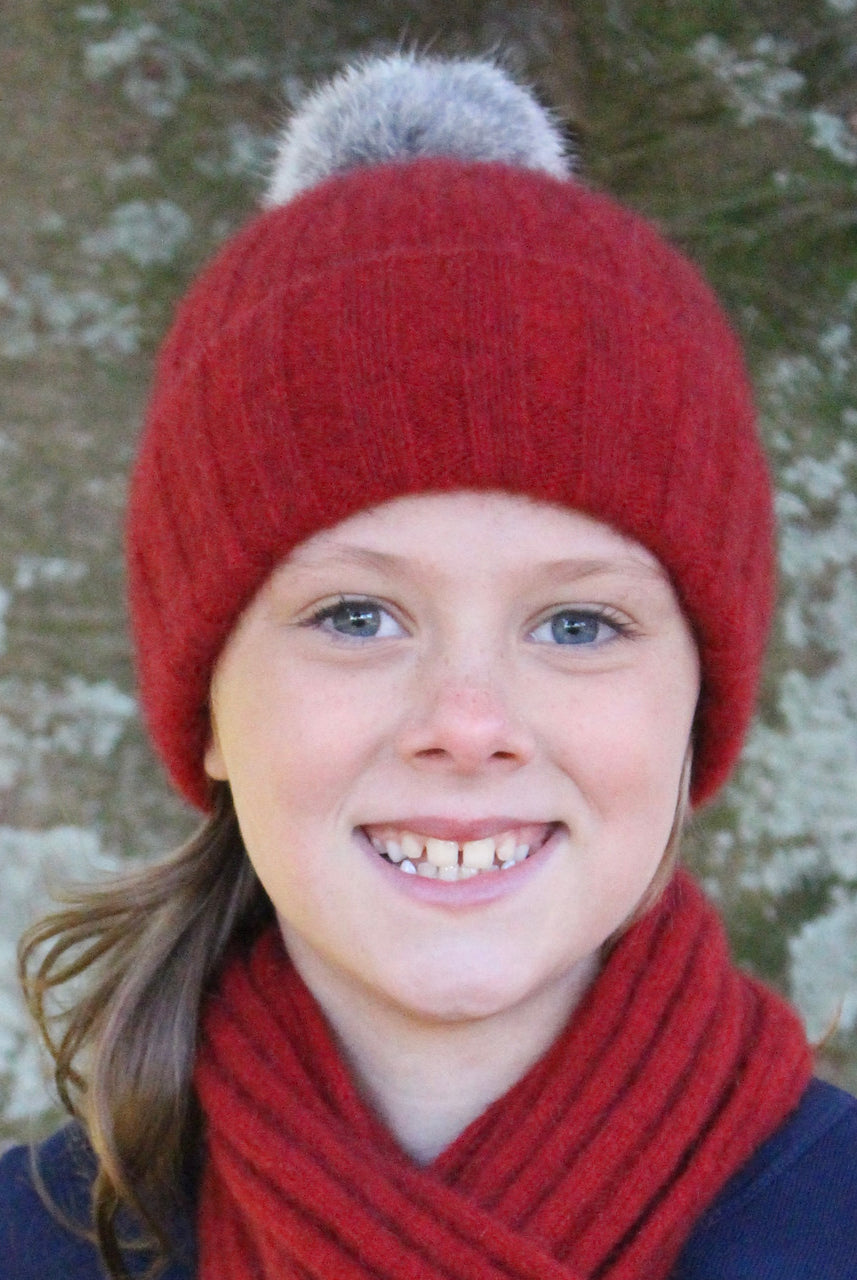 Child wearing beanie. Colour Red